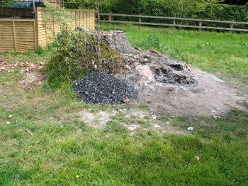 10. The excavated ash pits showing the small mound of extracted charcoal (sieved from the ash).