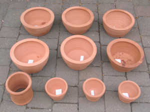 The pots. The ceramic lining for the gathering hole of the small furnace is shown at the bottom left