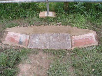 1. The fire pit, lined with bricks, tiles and daub.