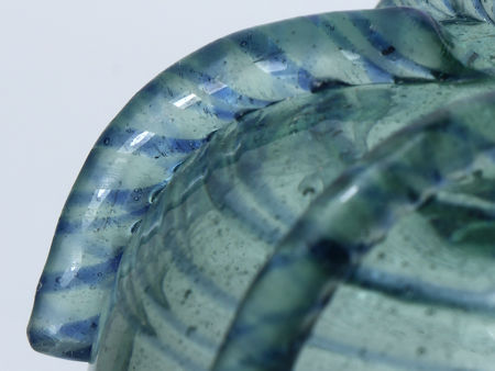 Detail of a twisted cane from Firing Four showing attack on the surface of the green glass, but not on the blue glass