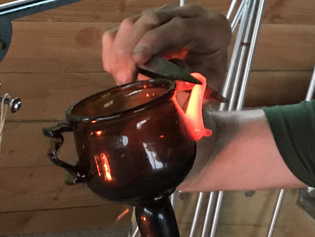 Two-handled beaker: pinching the thumbpiece