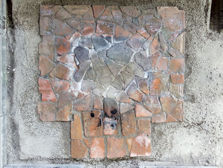 The hearth cleaned and dampened to show the tiles - note how the central tiles have greyed due to reduction