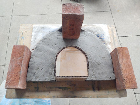 The damp collar with bricks to constrain it whilst drying