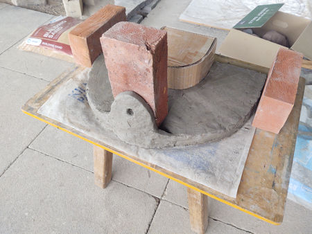 The damp collar with bricks to constrain it whilst drying